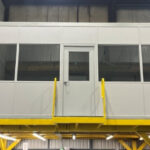 Elevated modular part-testing office built on an existing mezzanine for Ball Service Group